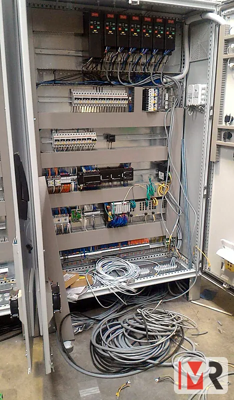 Large control panel being built with seven variable speed drives and a PLC